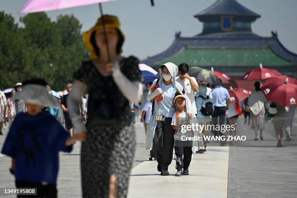 Tourists visit the Temple of Heaven on a hot day in Beijing on June 30, 2023.