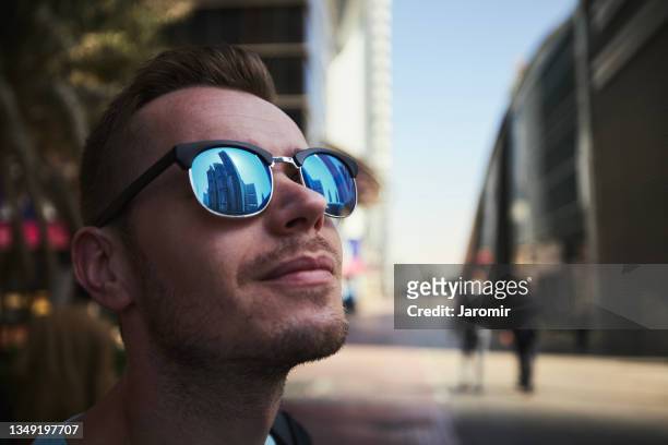 reflection of skyscrapers in sunglasses - sunglasses foto e immagini stock