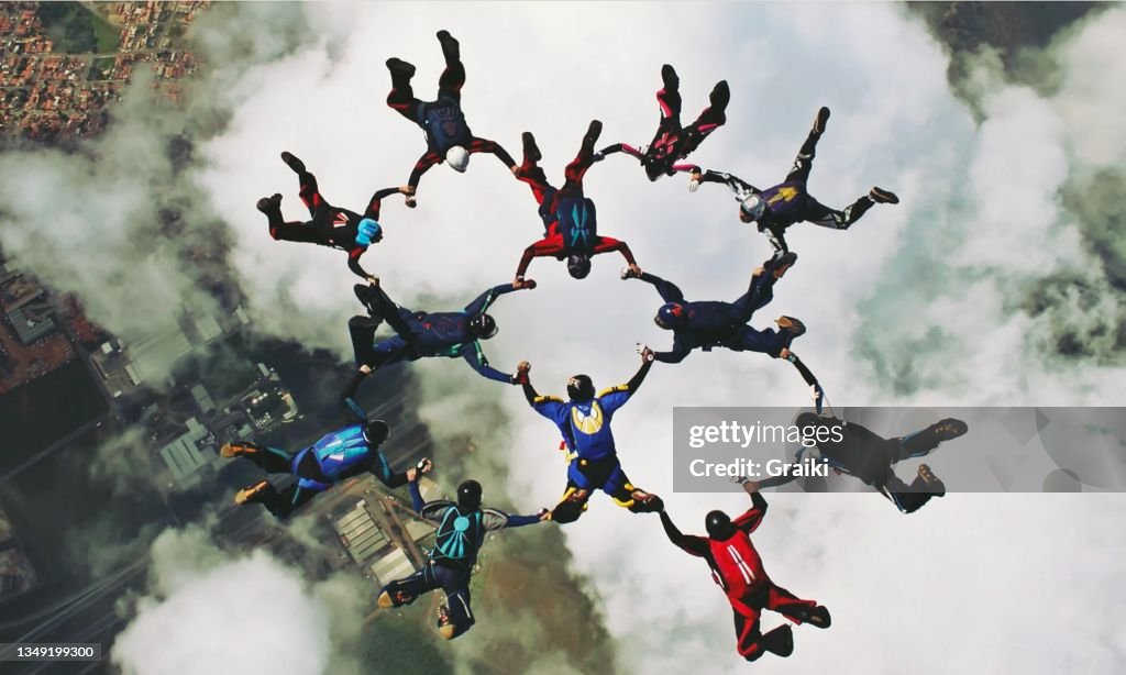 Group of skydivers holding hands