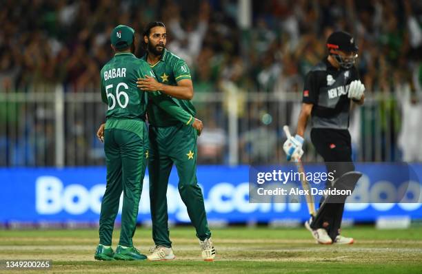 Imad Wasim of Pakistan celebrates the wicket of Daryl Mitchell of New Zealand with team mate Babar Azam during the ICC Men's T20 World Cup match...