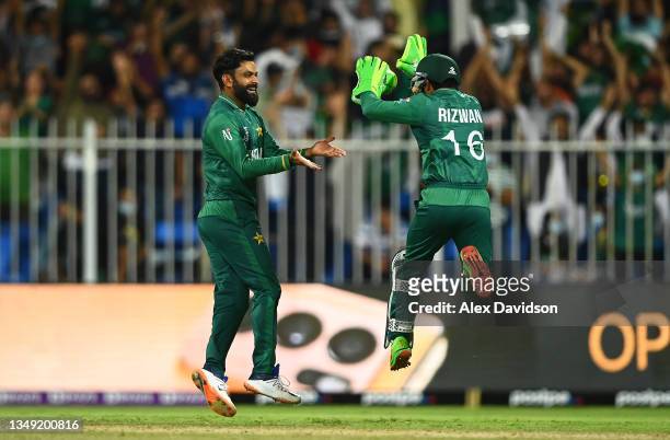 Mohammad Hafeez of Pakistan celebrates the wicket of Jimmy Neeshan of New Zealand with team mate Mohammad Rizwan during the ICC Men's T20 World Cup...