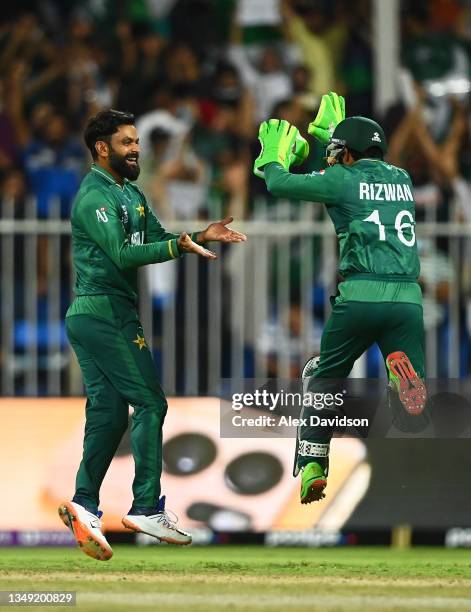 Mohammad Hafeez of Pakistan celebrates the wicket of Jimmy Neeshan of New Zealand with team mate Mohammad Rizwan during the ICC Men's T20 World Cup...