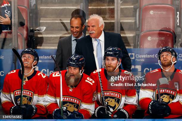 Florida Panthers Head Coach Joel Quenneville and Assistant Coach Derek MacKenzie smile on the bench after Joe Thornton scores against the Arizona...