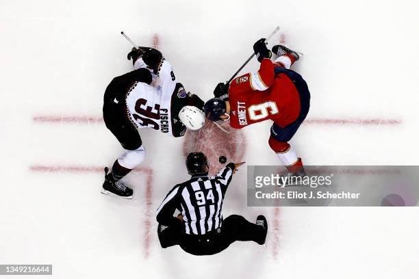 Linesmen Bryan Pancich drops the puck for a face off between Christian Fischer of the Arizona Coyotes and Sam Bennett of the Florida Panthers at the...