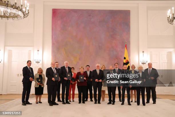 Acting Chancellor Angela Merkel and members of her government pose for a group photo after receiving their official decommissioning documents from...