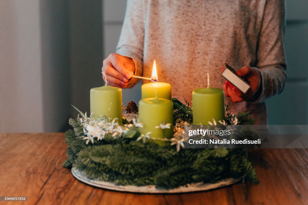 Lighting the first candle on swiss advent wreath.