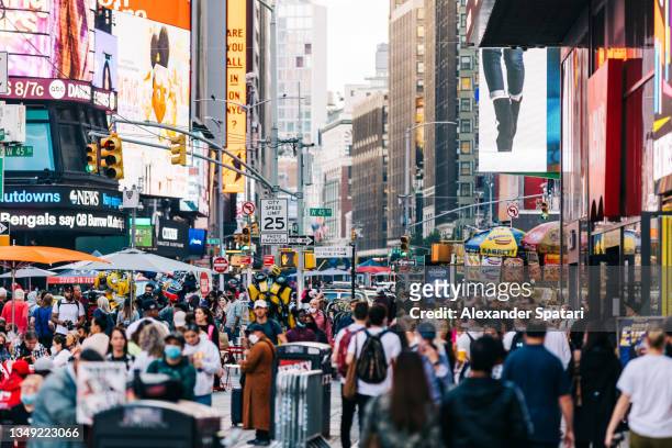 crowds of people on times square, new york city, usa - broadway manhattan stock pictures, royalty-free photos & images