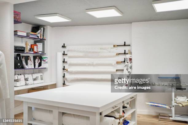 white sewing workshop with an ironing area - clothing design studio stock pictures, royalty-free photos & images