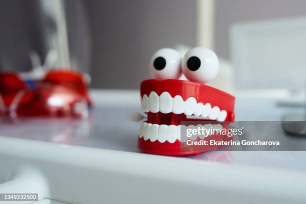 a figurine of a human tooths. - wind up toy foto e immagini stock