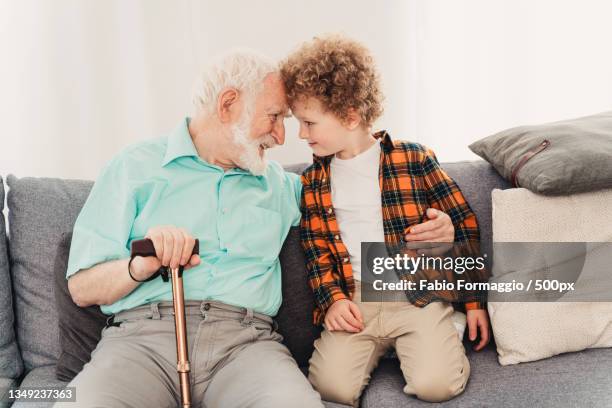 grandparents and grandson playing at home - nephew stock-fotos und bilder