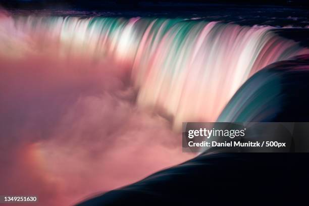 scenic view of waterfall against sky at sunset,niagara falls,ontario,canada - niagarawatervallen stockfoto's en -beelden