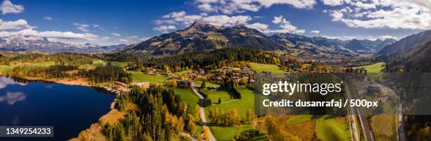 panoramic view of lake and mountains against sky,kitzbuhel,austria - kitzbühel stockfoto's en -beelden