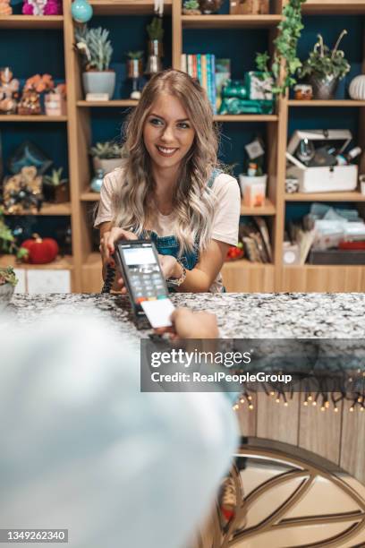 customer making wireless or contactless payment using credit card. - customers pay with contactless cards stock pictures, royalty-free photos & images