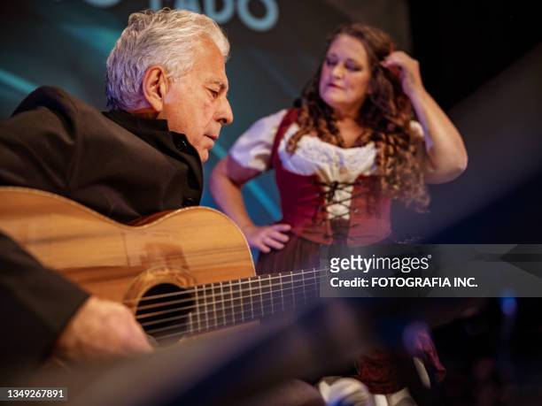mature performer and guitarist on the stage - duet stock pictures, royalty-free photos & images