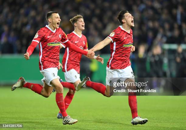 Maximilian Eggestein and Keven Schlotterbeck of Freiburg celebrate during the penalty shootout during the DFB Cup second round match between VfL...
