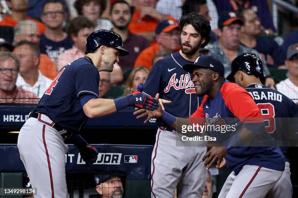 Marcell Ozuna of the Atlanta Braves congratulates Adam Duvall of the Atlanta Braves on his two run home run against the Houston Astros during the...