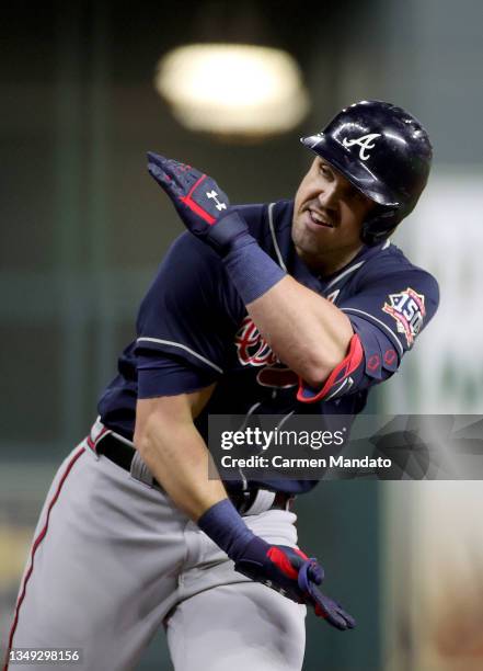 Adam Duvall of the Atlanta Braves celebrates after hitting a two run home run against the Houston Astros during the third inning in Game One of the...