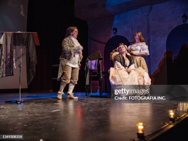 three actresses in period costumes on theatre stage - opera backstage stock pictures, royalty-free photos & images