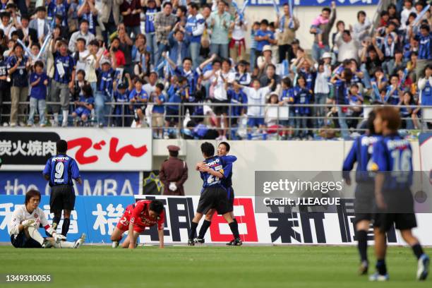 Masafumi Maeda of Gamba Osaka celebrates scoring his side's third goal with his team mate Hideo Hashimoto during the J.League J1 match between Gamba...