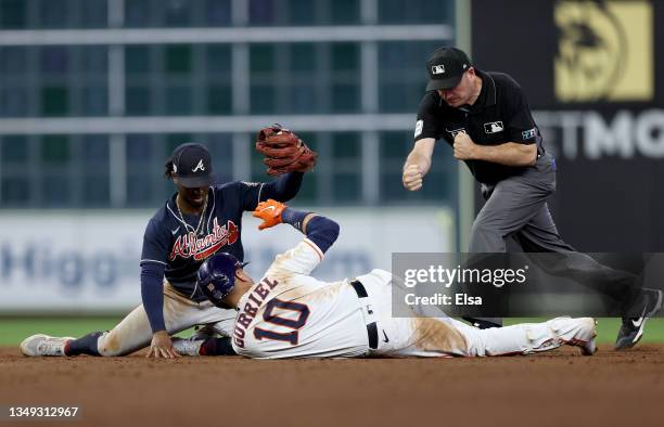 Yuli Gurriel of the Houston Astros is tagged out at second base by Ozzie Albies of the Atlanta Braves during the eighth inning in Game One of the...