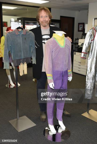 Bill Mumy poses with various costumes from season 1 of "Lost in Space" at the Auction Reception and Preview: Monsters & Friends: Featuring the Kevin...