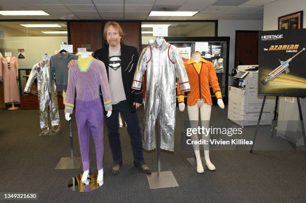Bill Mumy poses with various costumes from season 1 of "Lost in Space" at the Auction Reception and Preview: Monsters & Friends: Featuring the Kevin...