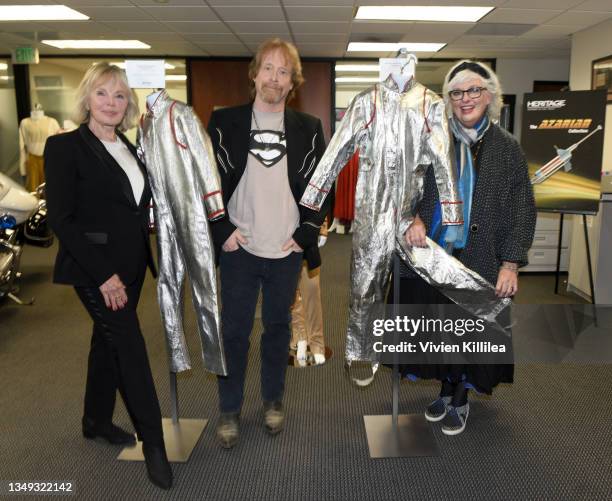 Marta Kristen, Bill Mumy and Angela Cartwright pose with costumes from season 1 of "Lost in Space" at the Auction Reception and Preview: Monsters &...