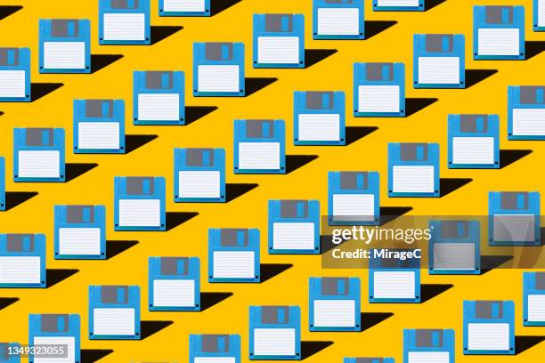 blue colored floppy disk repetition pattern - computer disk stock pictures, royalty-free photos & images