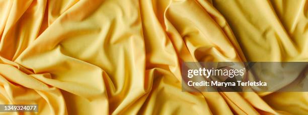 textured yellow fabric with ruffles and pleats. - silk garment stock pictures, royalty-free photos & images