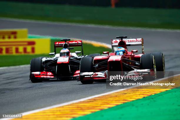 In front of Pirelli commercial advertising signs, Spanish Scuderia Ferrari Formula One team racing driver Fernando Alonso driving his F138 racing car...