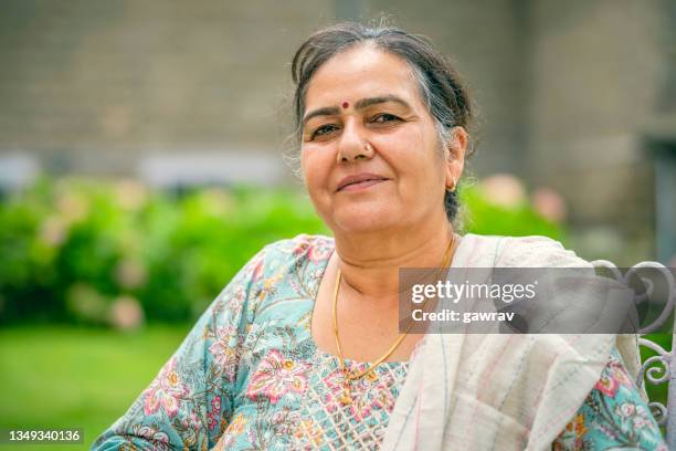 portrait of a happy senior woman. - indian ethnicity stock pictures, royalty-free photos & images