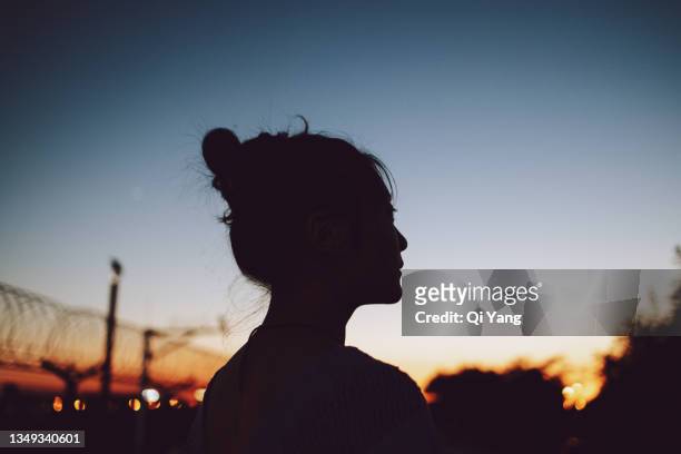 woman enjoying the sunset - natural change woman stockfoto's en -beelden