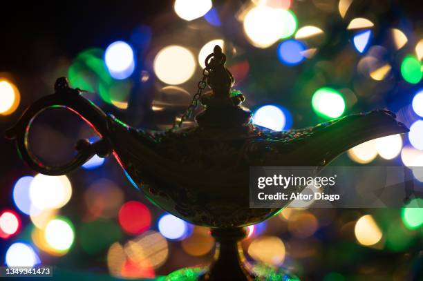 magic lamp with colorful lights in the background - genies lamp stock pictures, royalty-free photos & images