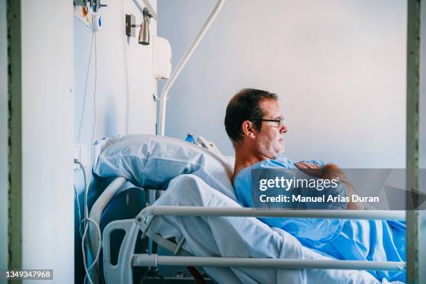 hospital bedridden patient - adult male hospital bed stock pictures, royalty-free photos & images