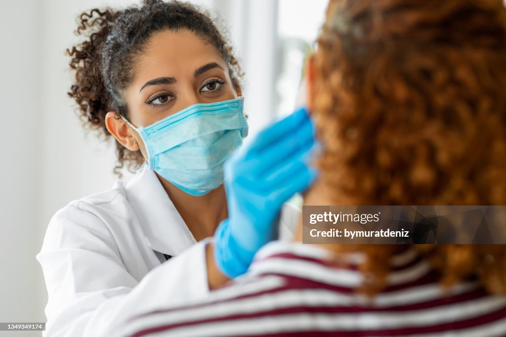 Doctor wearing surgical mask examining