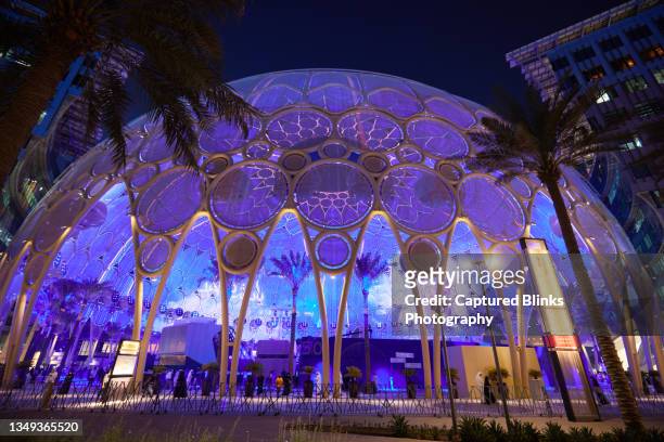 the al wasl dome at the expo 2020 site in dubai illuminated at night - expo 2020 dubai stock pictures, royalty-free photos & images