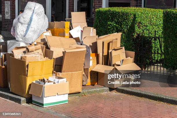 piles of cardboard boxes placed on the side walk - cardboard box stock pictures, royalty-free photos & images