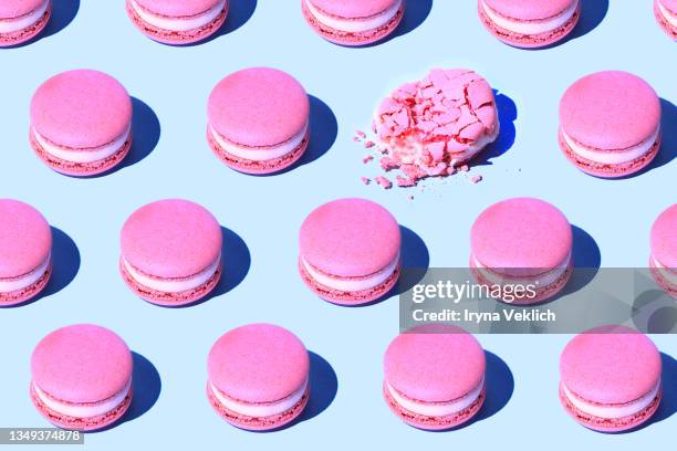 pattern made of tasty pink purple color macaroons on pastel blue background. - macaron stock pictures, royalty-free photos & images