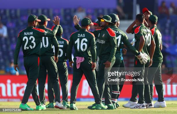 Nasum Ahmed of Bangladesh celebrates the wicket of Jos Buttler of England with their team mates during the ICC Men's T20 World Cup match between...