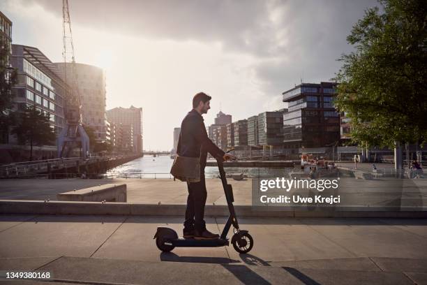 young man on e-scooter in the city - hamburg stock pictures, royalty-free photos & images