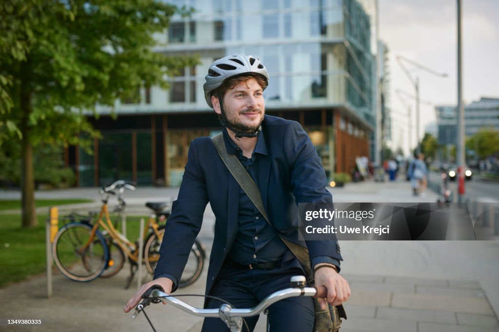 Happy young man on bicycle