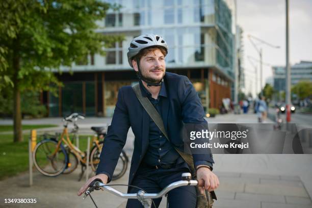 happy young man on bicycle - bike work stockfoto's en -beelden