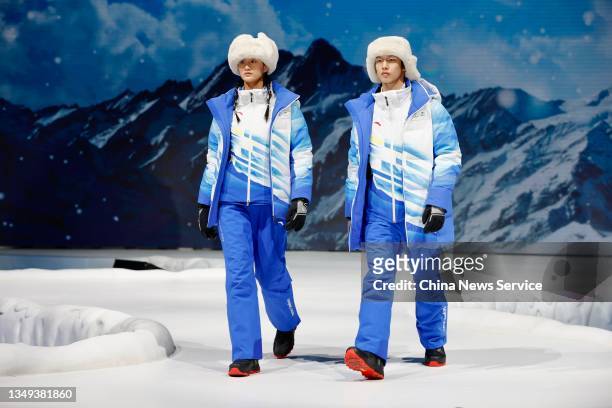 Models showcase uniforms and accouterments for volunteers during the release ceremony of uniforms and accouterments for Beijing 2022 Olympic and...