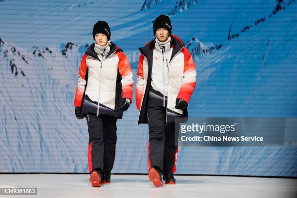 Models showcase uniforms and accouterments for staff during the release ceremony of uniforms and accouterments for Beijing 2022 Olympic and...