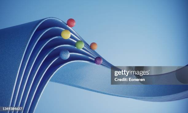 multi colored balls moving on the ribbons - 2021 trends stock pictures, royalty-free photos & images