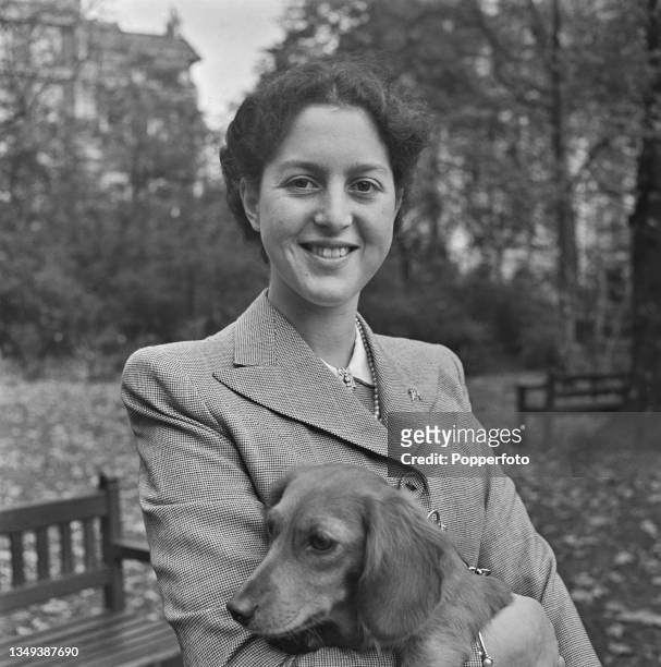 Princess Alexandra of Greece , fiancee of King Peter II of Yugoslavia, holds a pet dog in Grosvenor Square Gardens in London during World War II on...