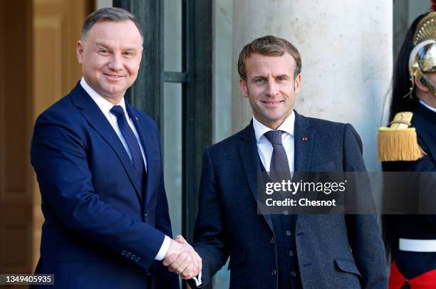 French President Emmanuel Macron welcomes Polish President Andrzej Duda as he arrives for a working lunch at the Elysee Palace on October 27, 2021 in...