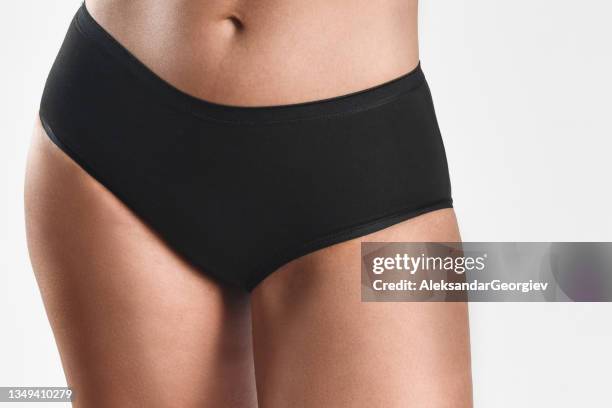 front view of black underpants on female standing model with white background - blonde long legs 個照片及圖片檔