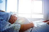 Close-up of a pregnant woman's belly in hospital
