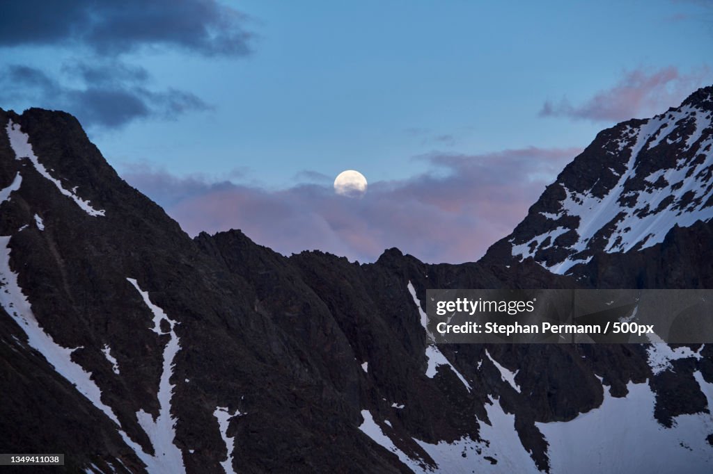 Scenic view of snowcapped mountains against sky during sunset